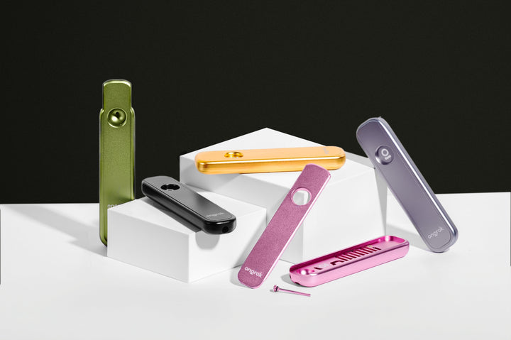 ONGROK Aluminum Cooling Pathway Pipe in green, gold, black, silver and pink on white steps against a black backdrop