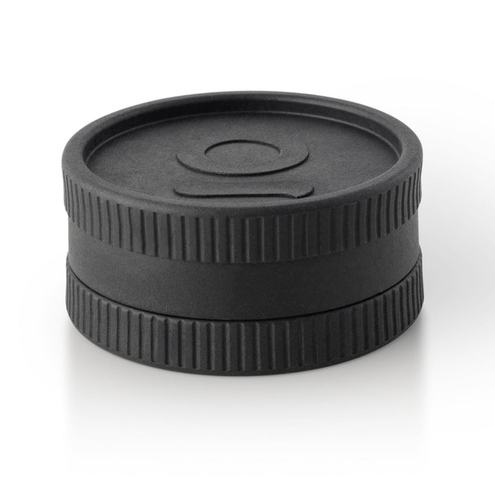 ONGROK Plant-Based Hemp Grinder in black, closed, angled view showing the logo lid and ridged grip