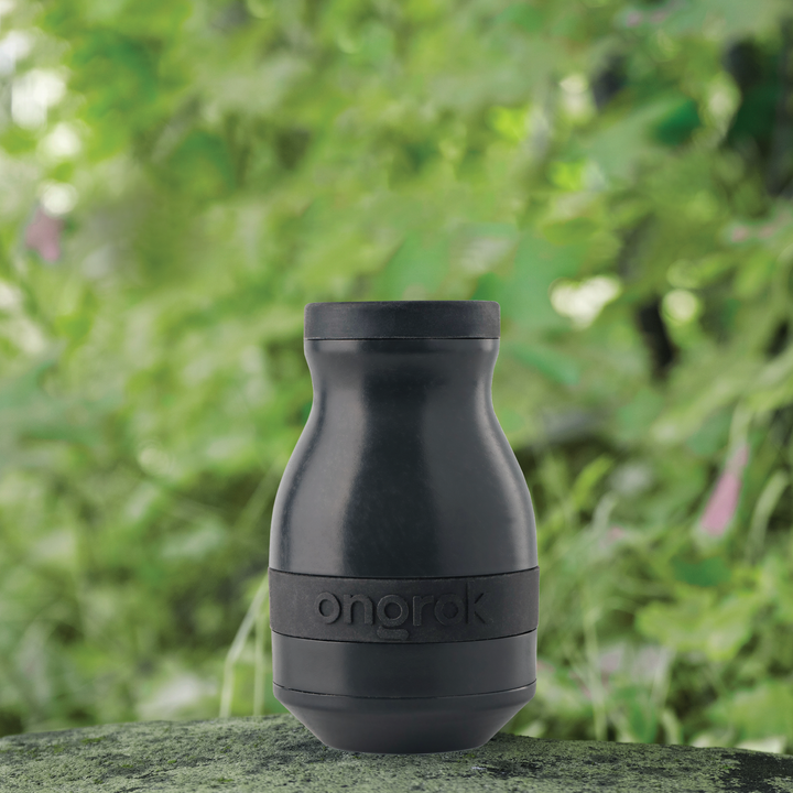ONGROK Plant-Based Filter in black standing on a mossy rock outdoors in front of green leaves