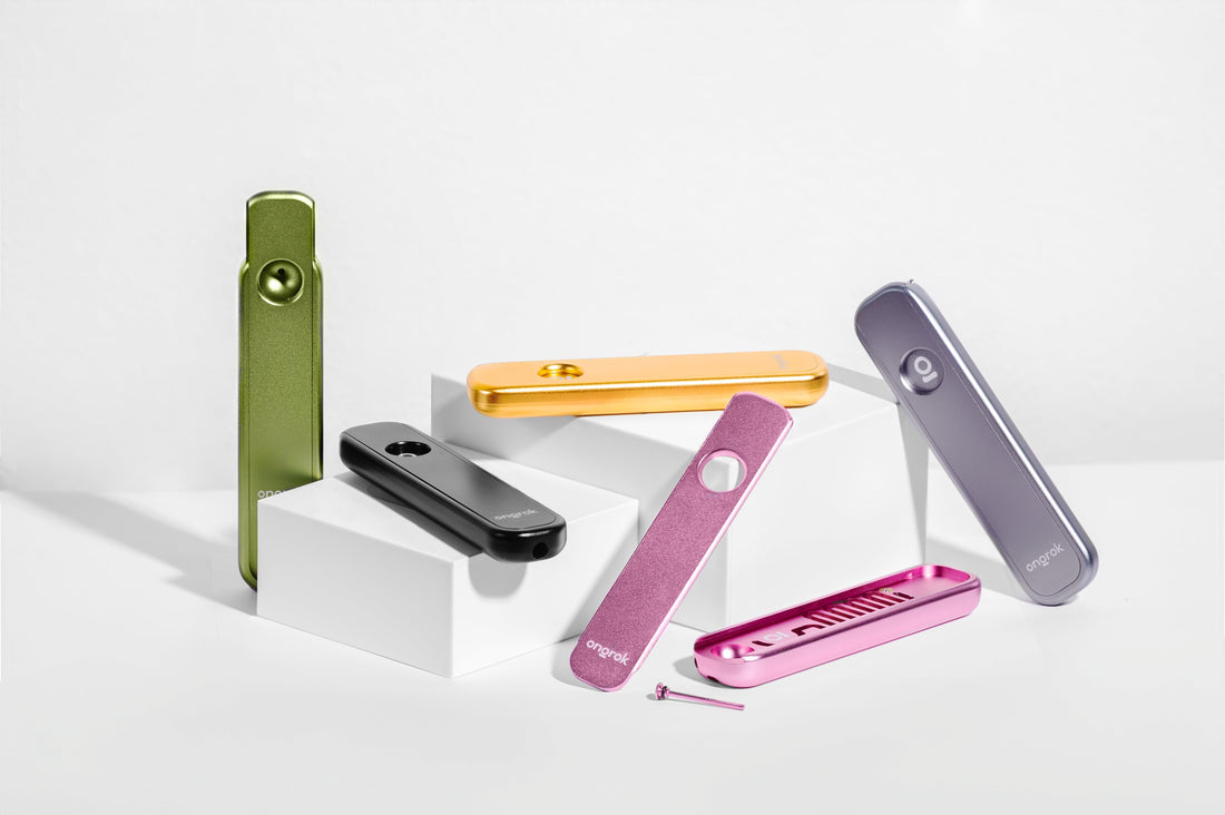 ONGROK Aluminum Cooling Pathway Pipe in green, gold, black, silver and pink on white steps against a white backdrop