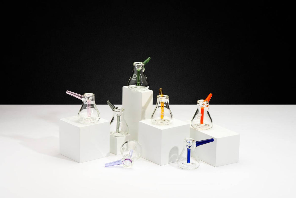 Scandinavian Pocket Bubblers in several colors on white plinths against a black wall