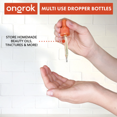 Hand using an ONGROK Glass Dropper Bottle, headed Multi use, store homemade beauty oils, tinctures and more