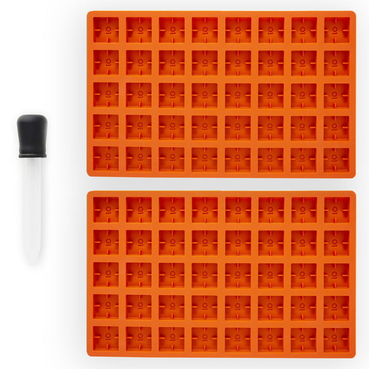 Two ONGROK Scored Gummy Molds in orange silicone, 40 square cavities each, beside a dropper