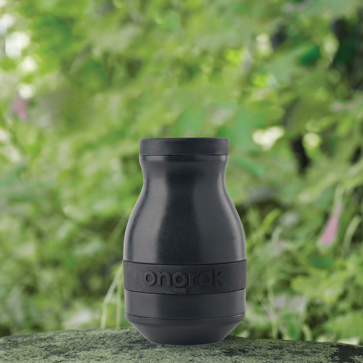 ONGROK Plant-Based Filter in black standing on a mossy rock outdoors in front of green leaves